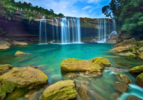 Waterfall and turquoise pools in Meghalaya on a tour from Shillong